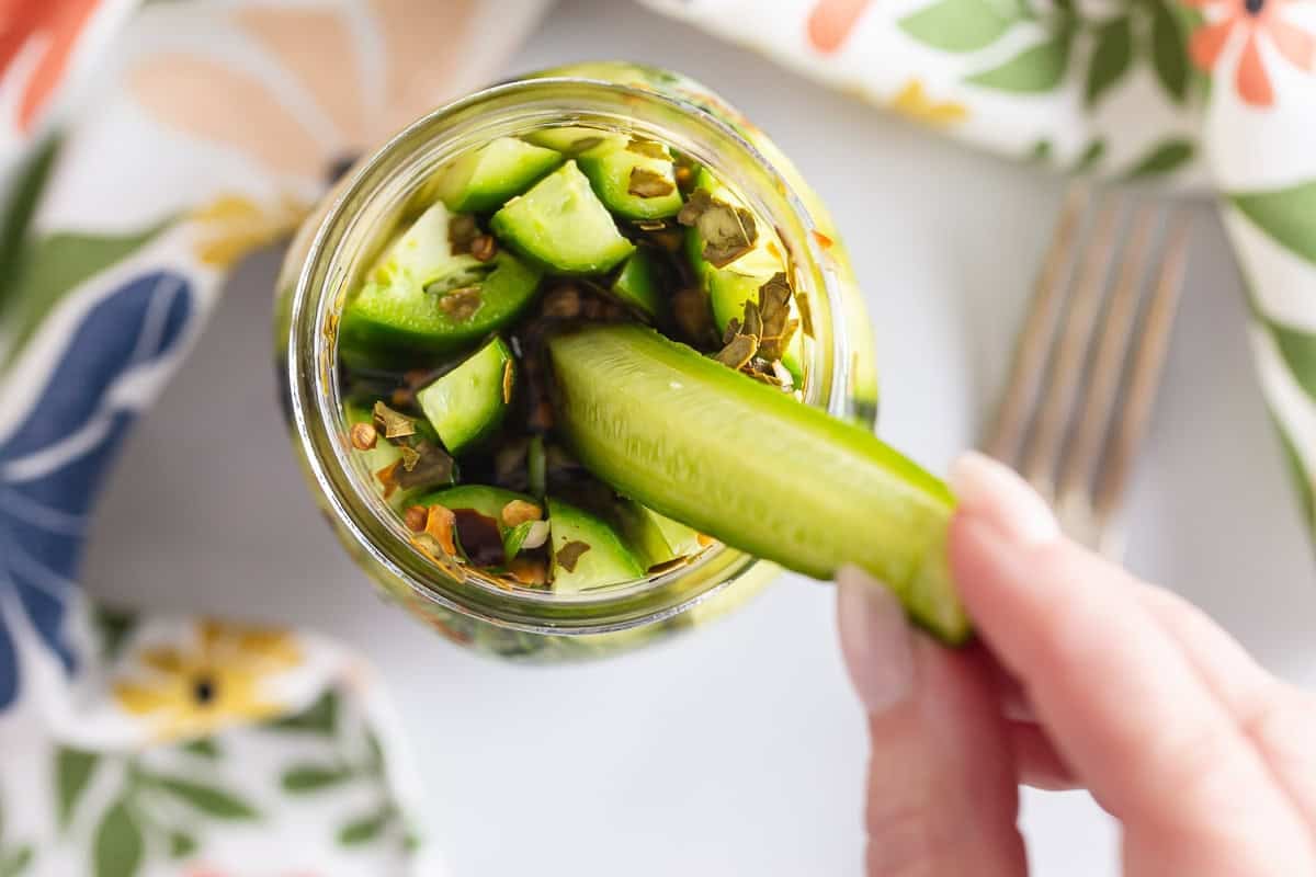 Dill pickle spears in a jar in an overhead view.