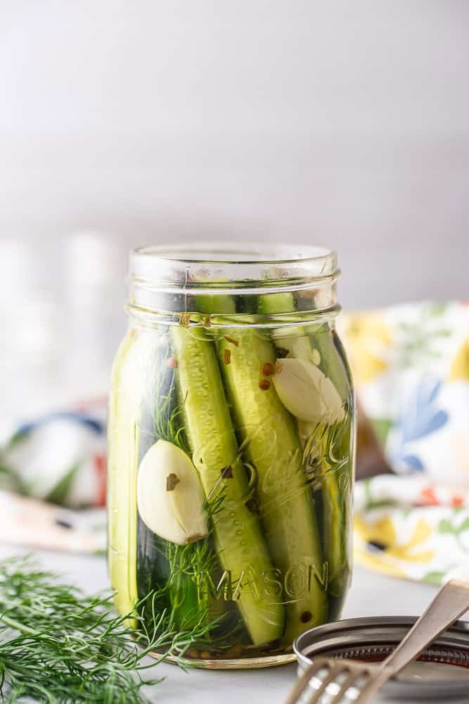 Homemade dill pickles in a canning jar.