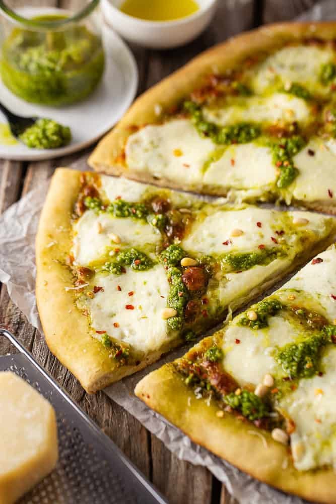 Pesto pizza cut into slices
