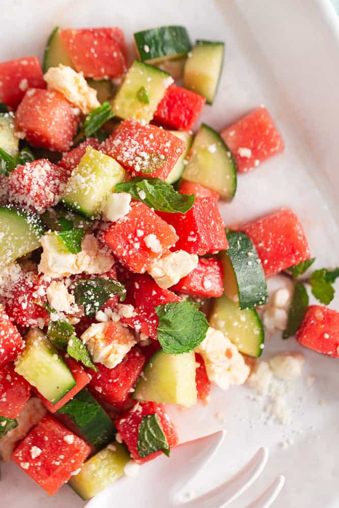 Watermelon salad on a white plate.