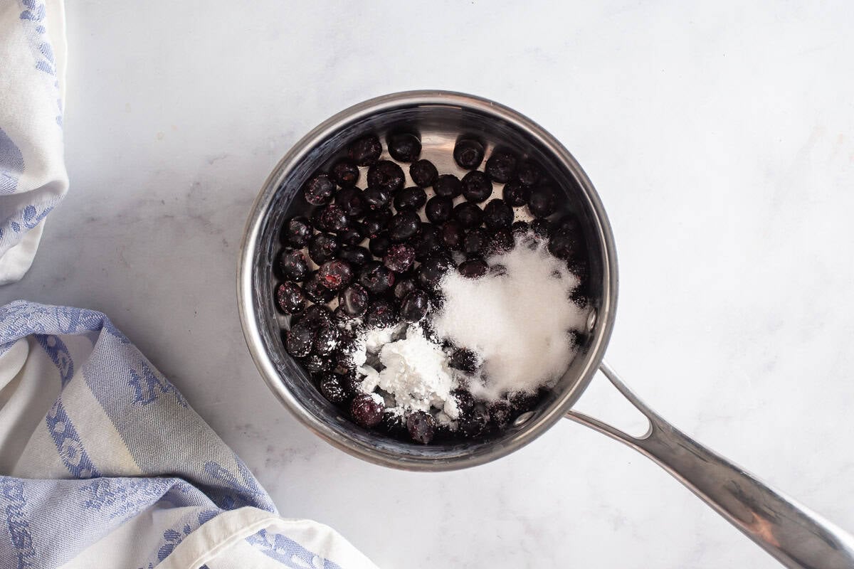 Blueberries, sugar, and cornstarch in a sauce pot.