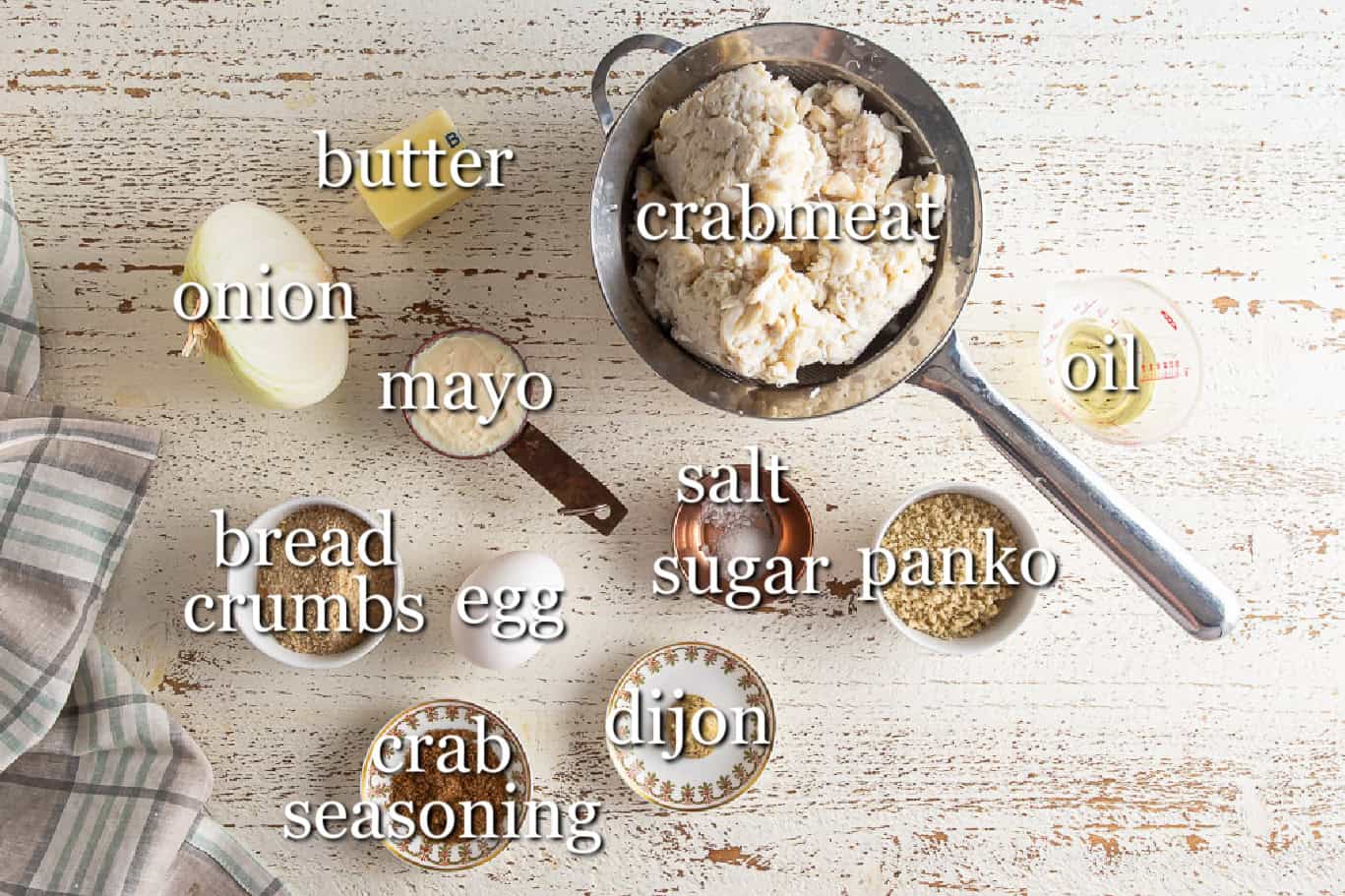 Ingredients for homemade crab cakes in separate containers.