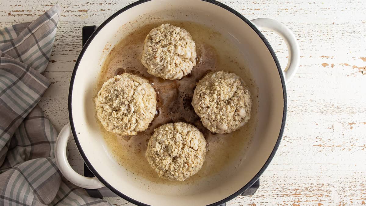 Sauteing crab cake patties in a skillet