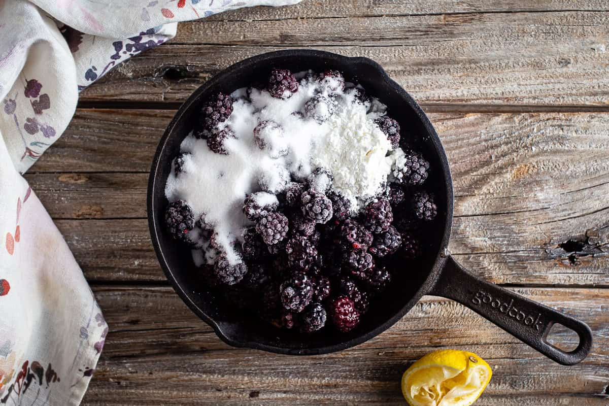Blackberries in a skillet with sugar and cornstarch.