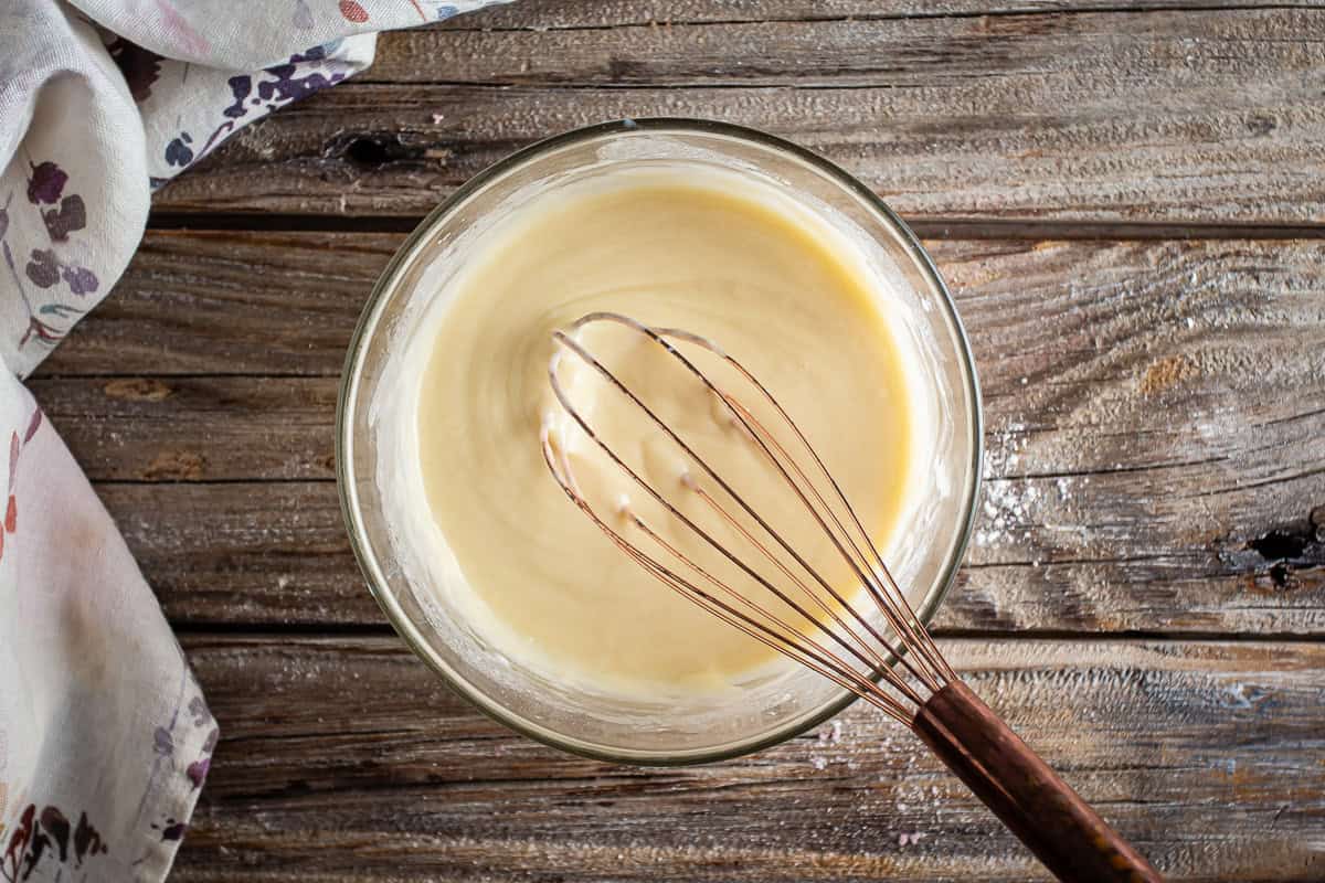 Cobbler batter in a glass bowl after being mixed together.