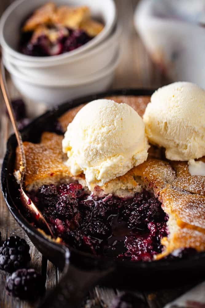 Finished Blackberry cobbler in a cast iron skillet.