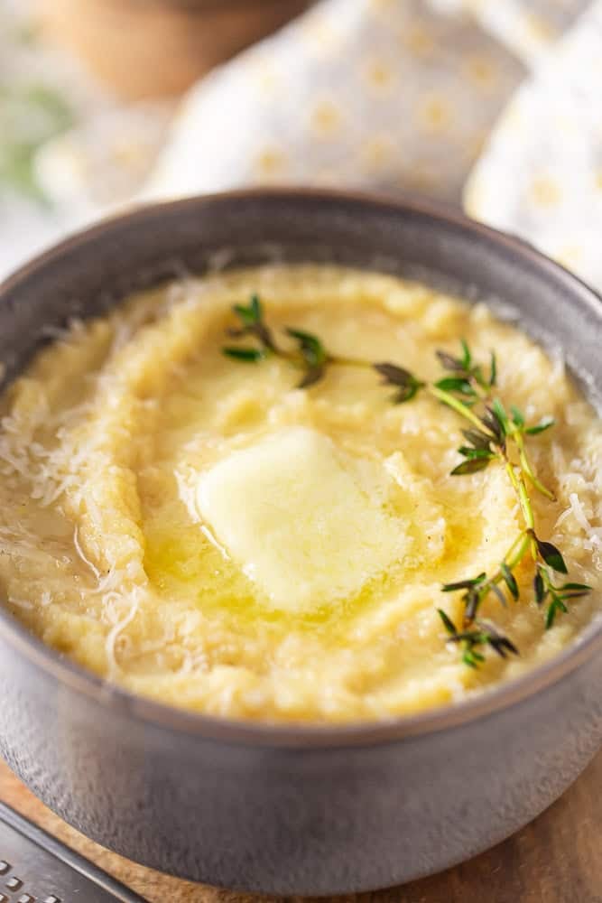 Polenta with butter and thyme in a bowl