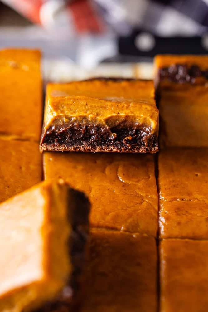 Pumpkin pie brownies cut and stacked to see the layers