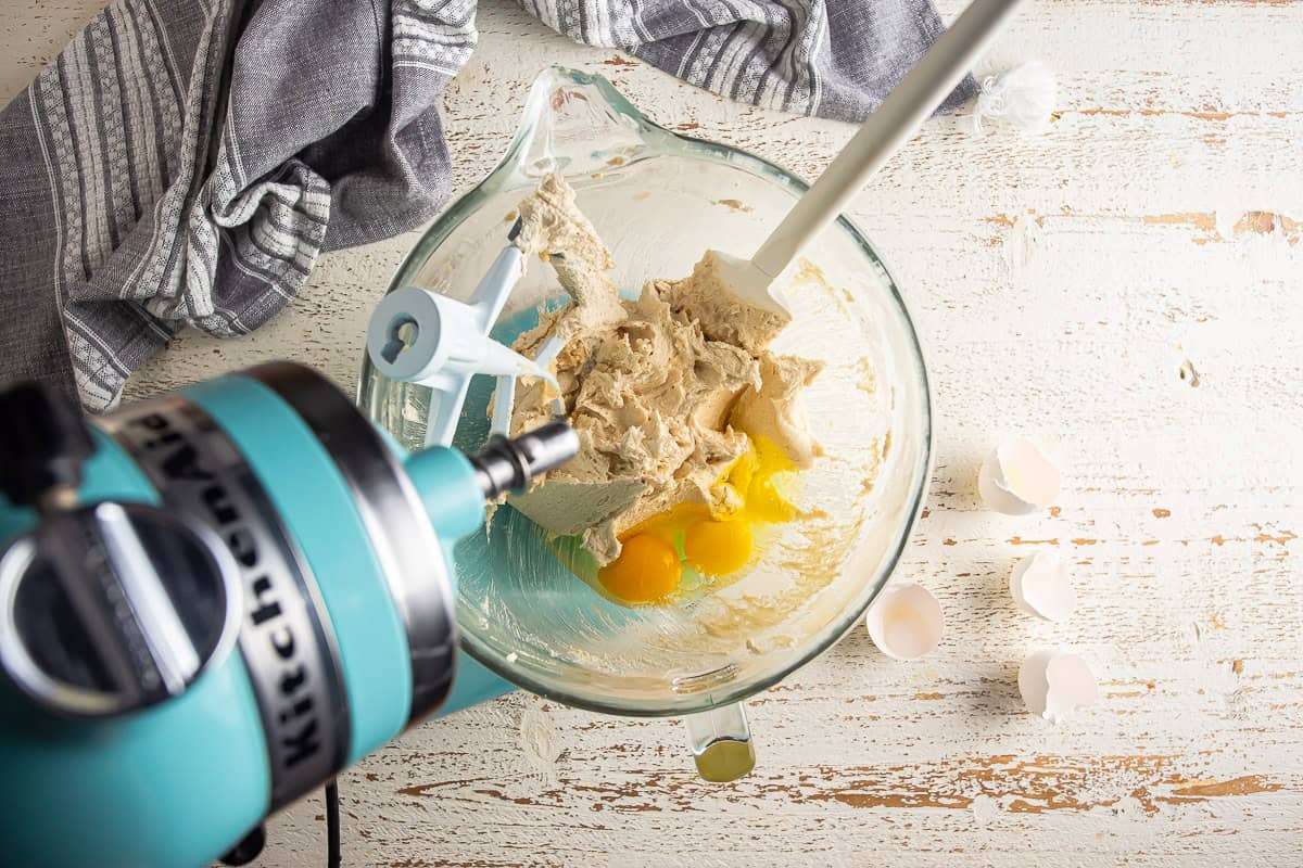 Adding eggs to the creamed butter and sugar for homemade cowboy cookies