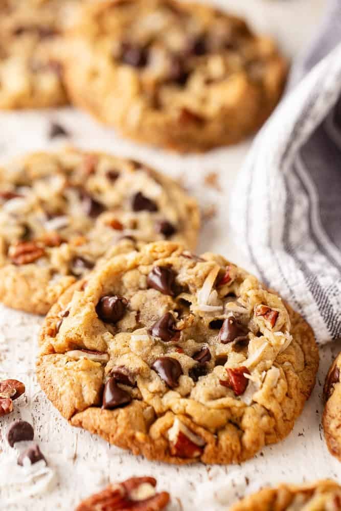 Cowboy cookies on a white background with a kitchen towel