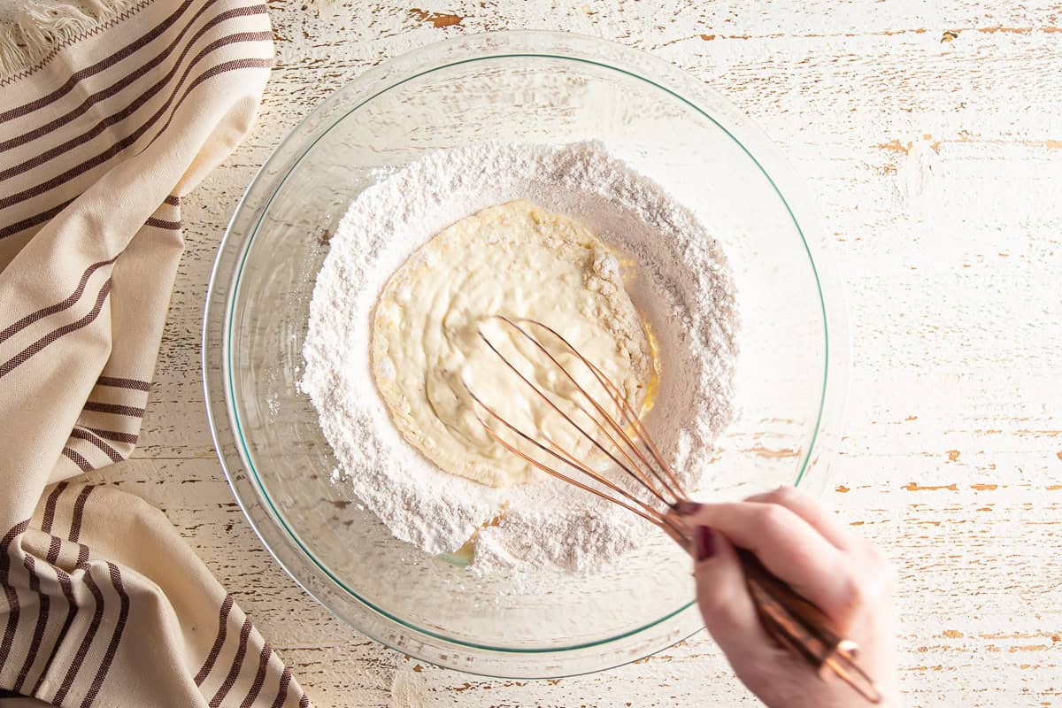Whisking the wet and dry ingredients together for baked donut batter