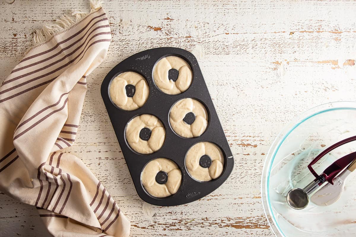 Unbaked donuts in a donut pan
