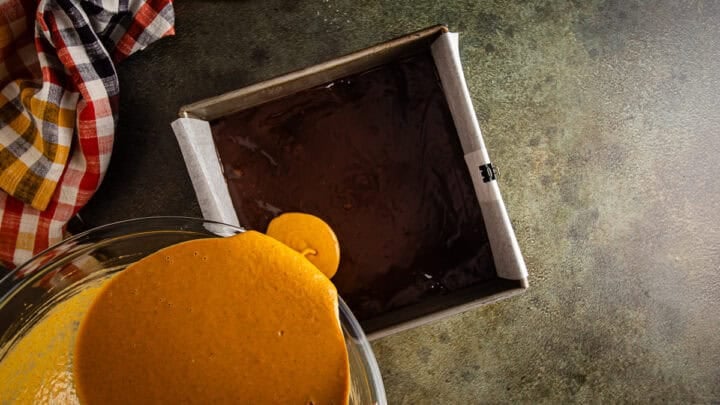 Adding the pumpkin pie layer to pumpkin pie brownies