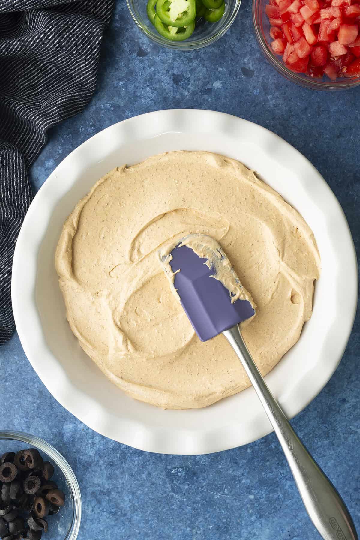 Dip spread into a pie dish