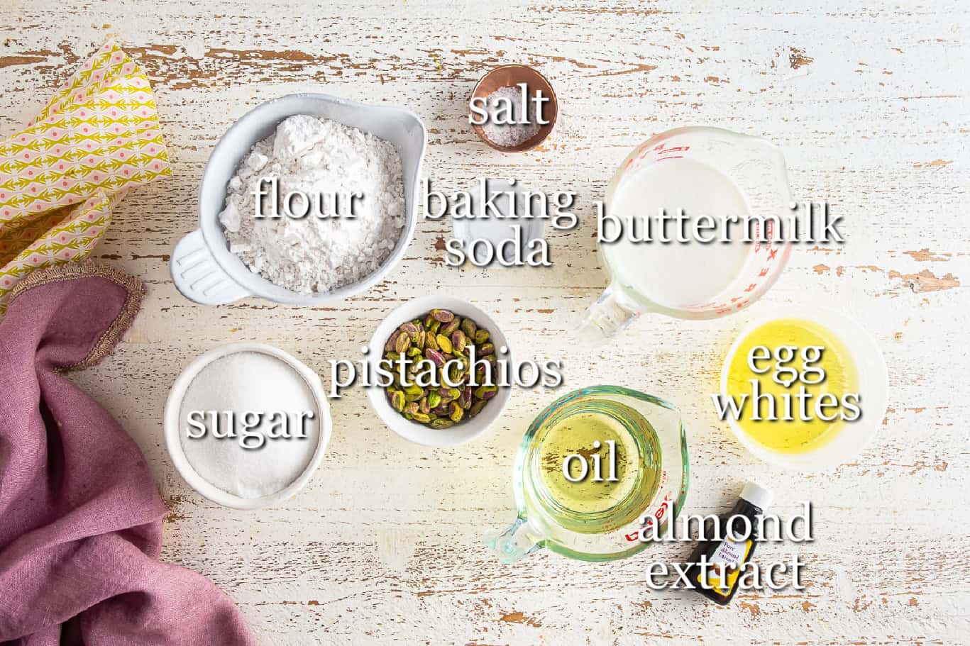 Ingredients for pistachio cake in separate containers.