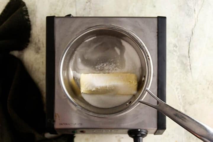 Melting butter and sugar with water and salt to make toffee