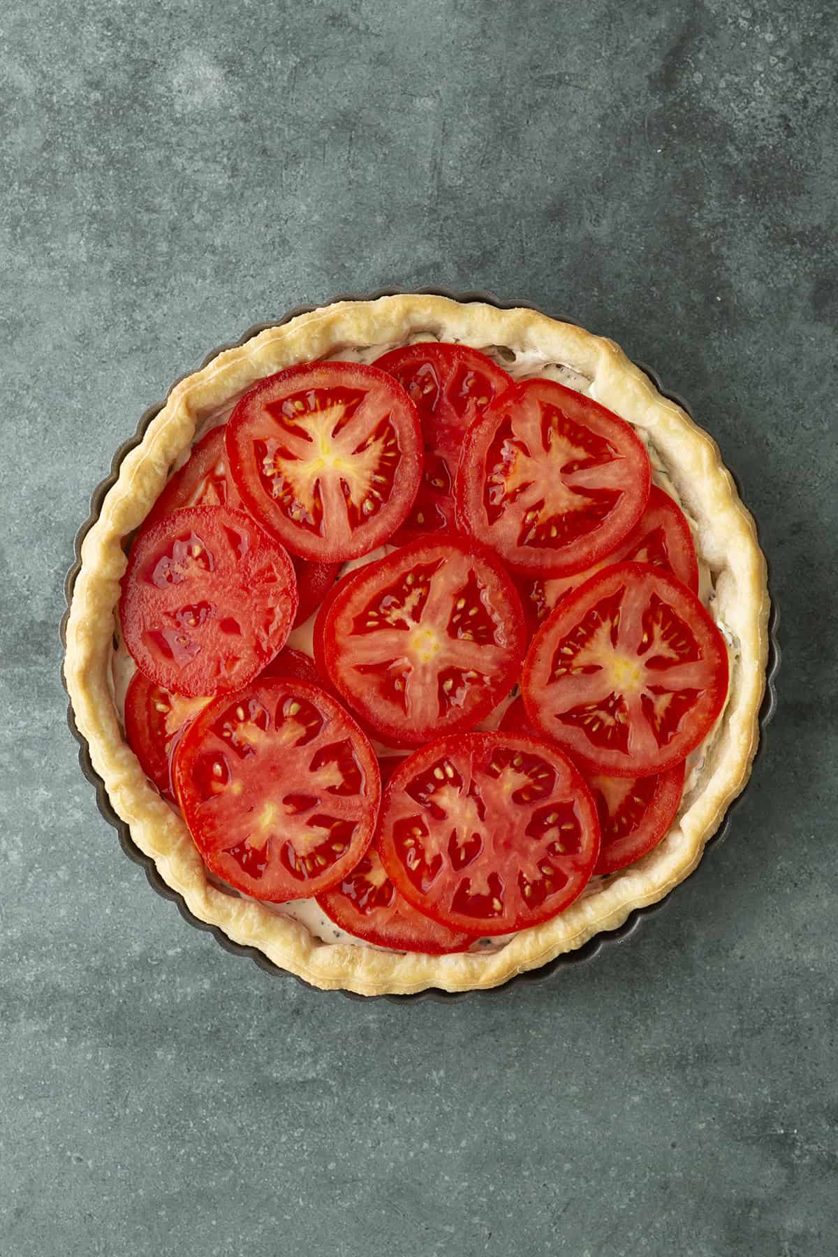Tomatoes layered over filling