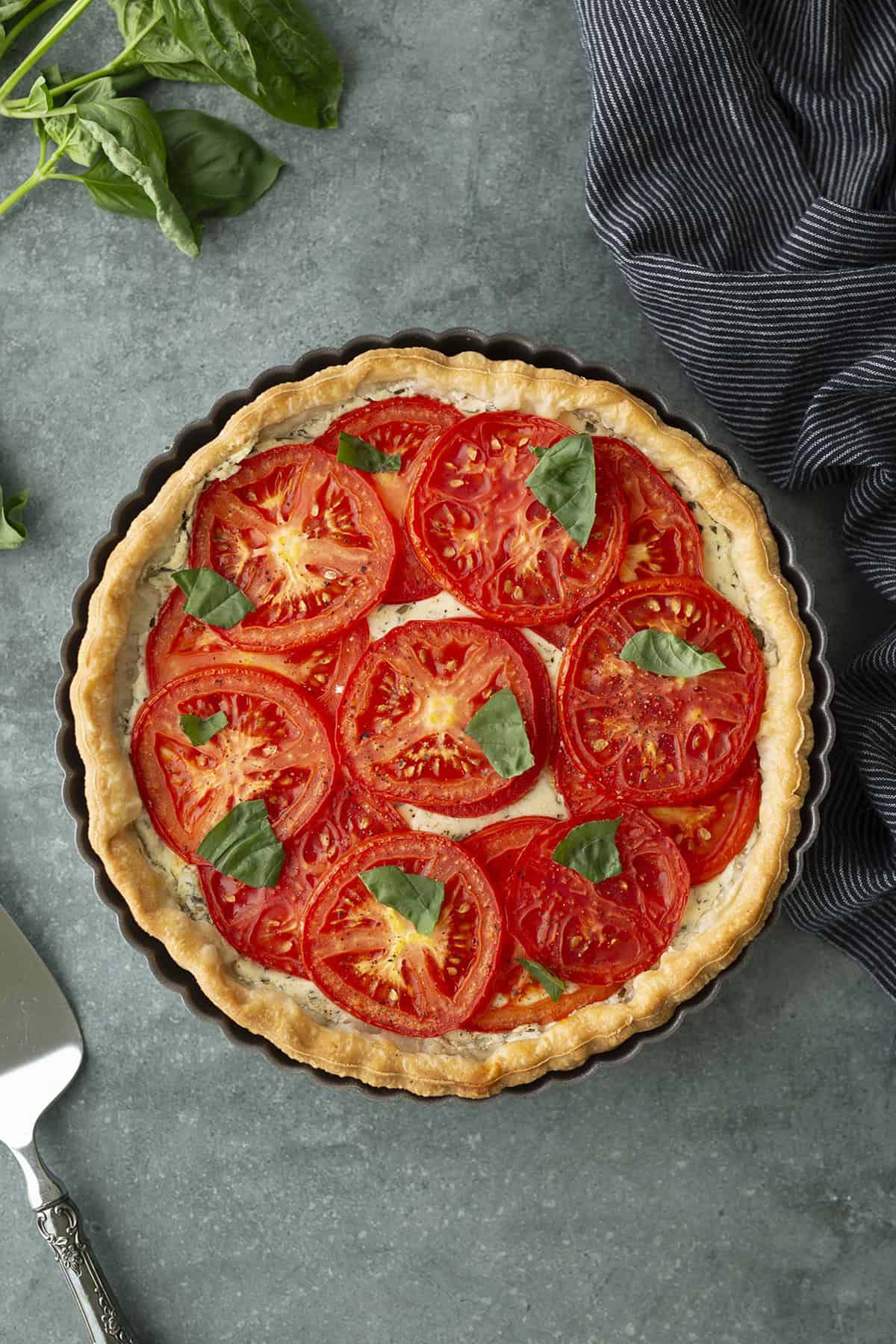 Tomato tart with basil leaves.