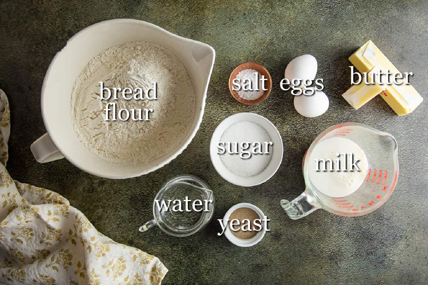 Ingredients for baking Parker House Rolls including bread flour, salt, eggs, butter, sugar, milk,