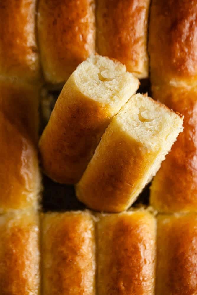 Close-up of soft, fluffy Parker House rolls with golden crust.