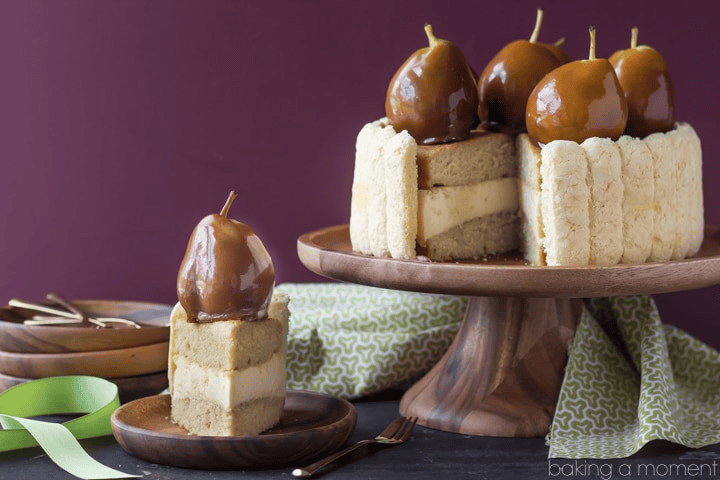 Caramel-covered pears and cake slices on a cake stand for dessert.